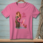 Pink t-shirt with a mermaid sitting on a post and the text "The tail has spoken."