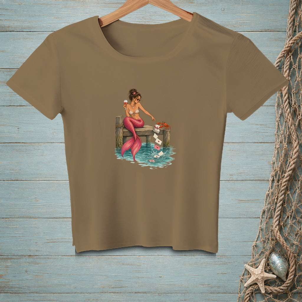 Brown t-shirt with a mermaid on a dock dropping letters into water.