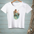 White t-shirt with a mermaid holding a drink, sitting on a pier post with a crab.