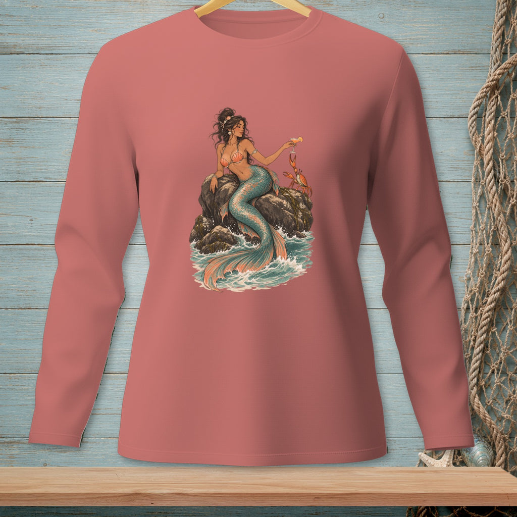 Mermaid with crab and cocktail on a rock surrounded by waves, printed on a pink long-sleeve shirt.