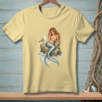 Mermaid sitting on rock with seashell bra and seagull eating food.