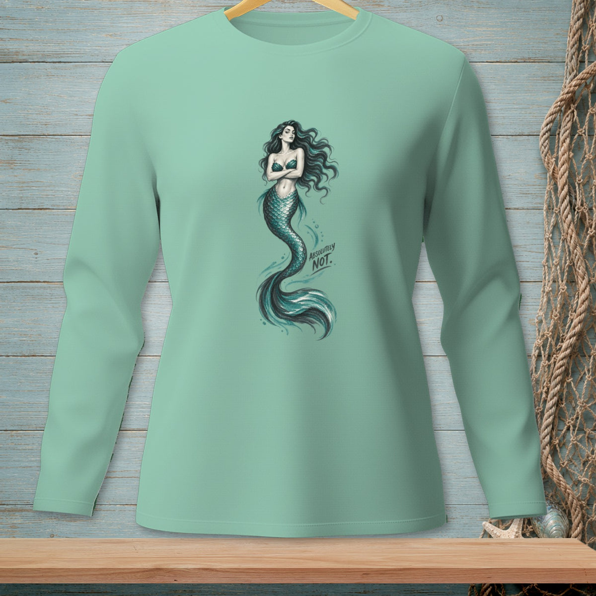 Mint long-sleeve shirt with a mermaid graphic and the text "ABSOLUTELY NOT."