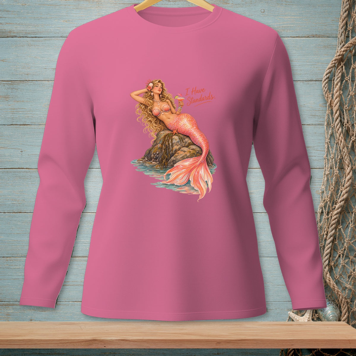 Pink long-sleeve shirt with a graphic of a mermaid and text "I Have Standards."