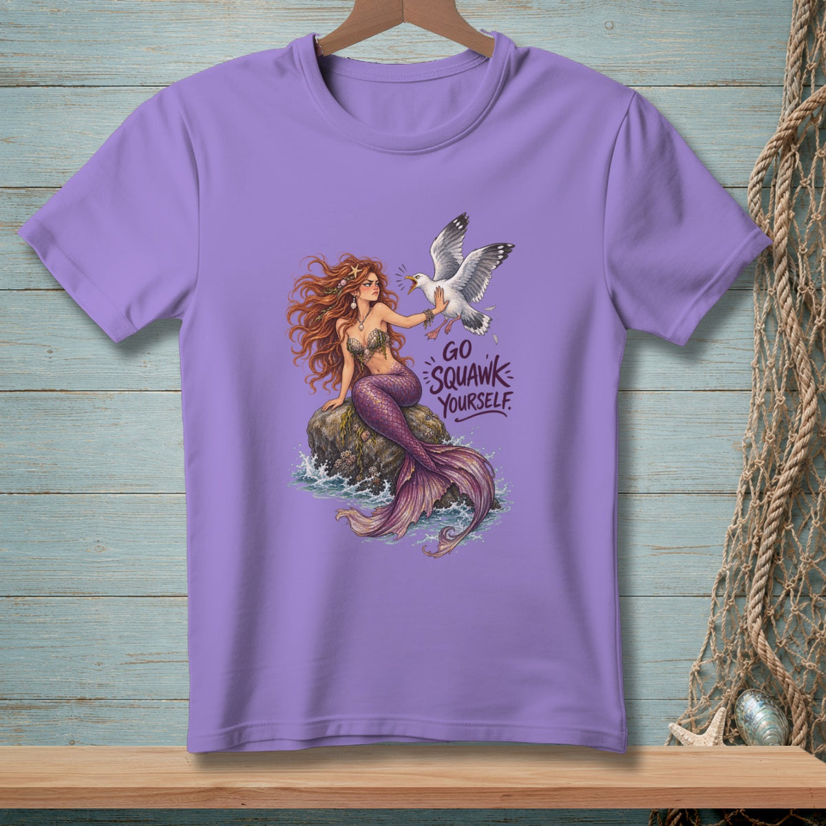 Purple t-shirt with a mermaid and seagull design, text reads "Go Squawk Yourself."