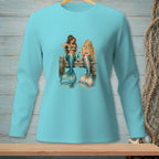 Two mermaids sit on a dock, drinking wine by the water.