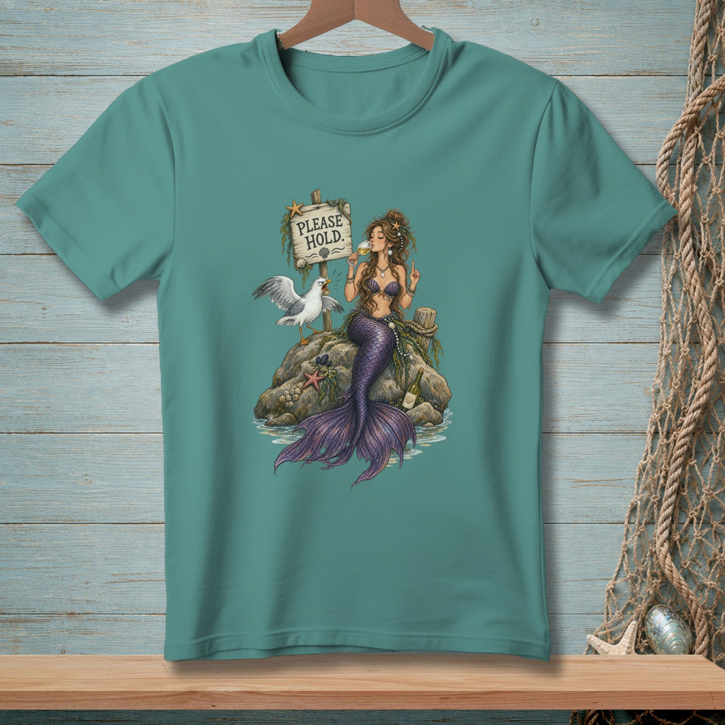 Mermaid and seagull sit on a rock by a "Please Hold" sign, drinking wine.