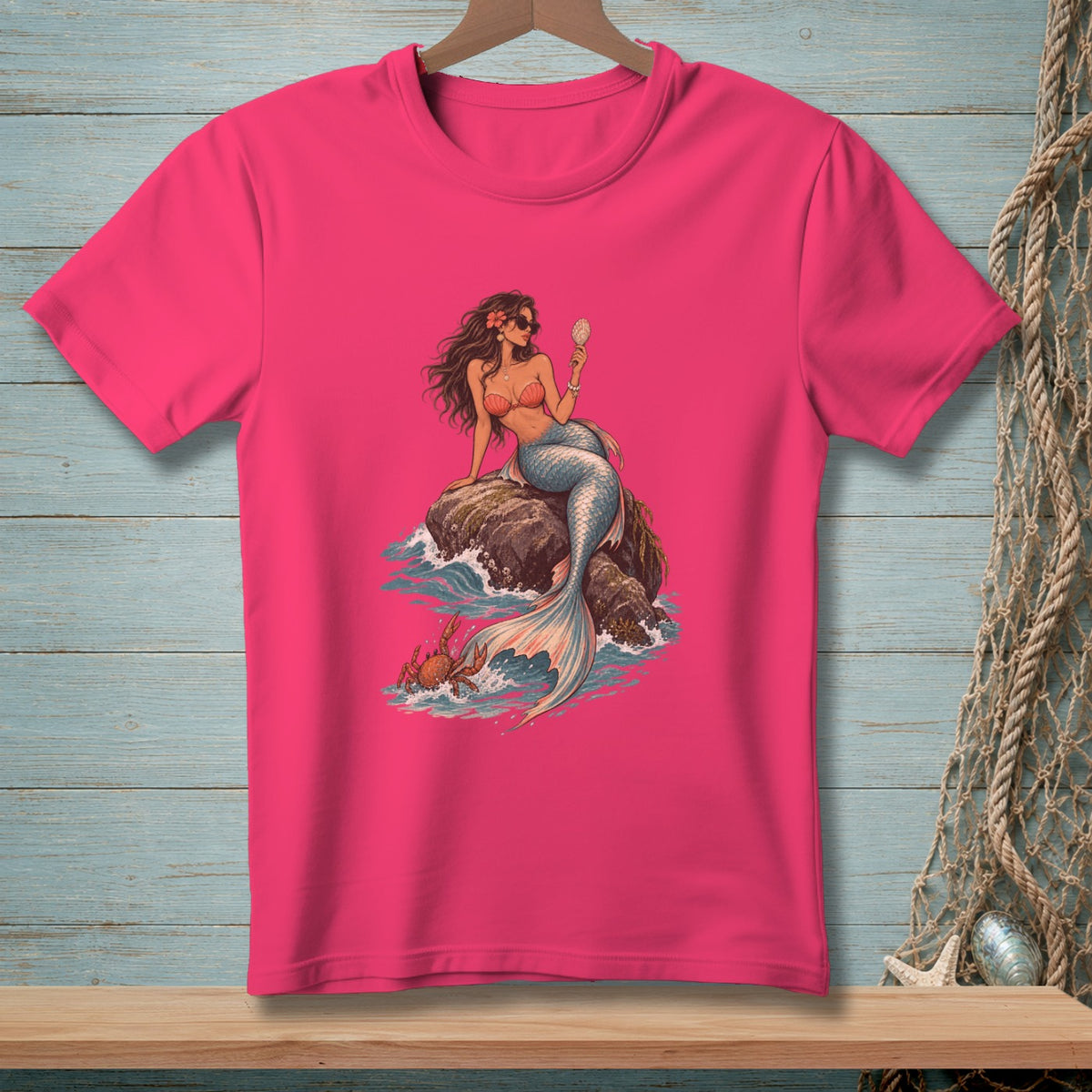 Mermaid with sunglasses and shell mirror sitting on rock with crab in waves.