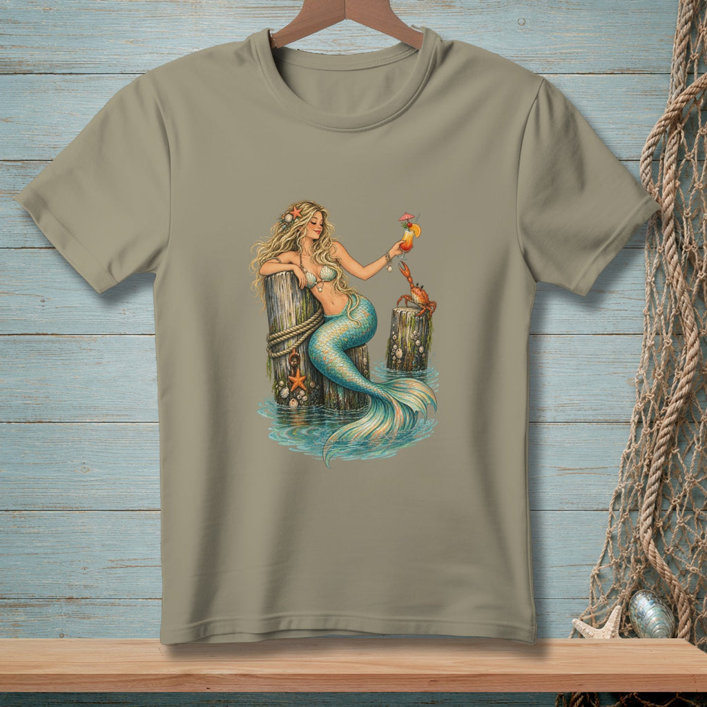 Mermaid with a cocktail and crab resting on wooden pilings in water.