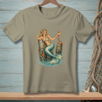 Mermaid with a cocktail and crab resting on wooden pilings in water.