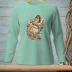 Mermaid reading on a rock with crabs on a beach, displayed on a mint green long-sleeve shirt.
