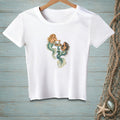 White t-shirt with graphic of two mermaids enjoying drinks in water.