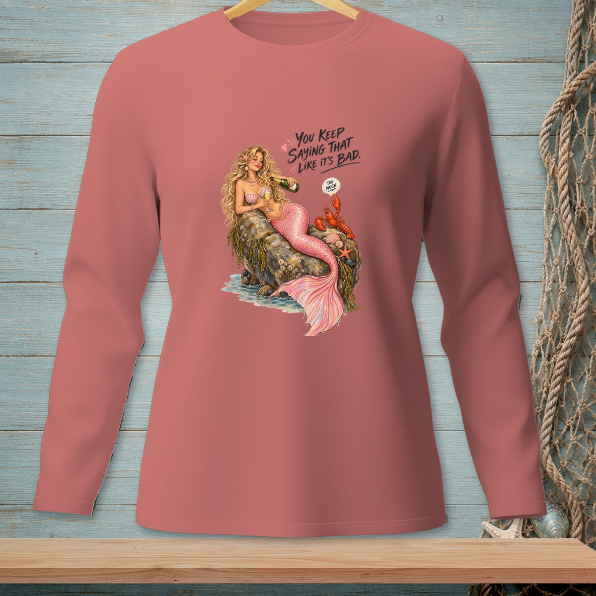 Mermaid with champagne on rock, text "You keep saying that like it's bad."