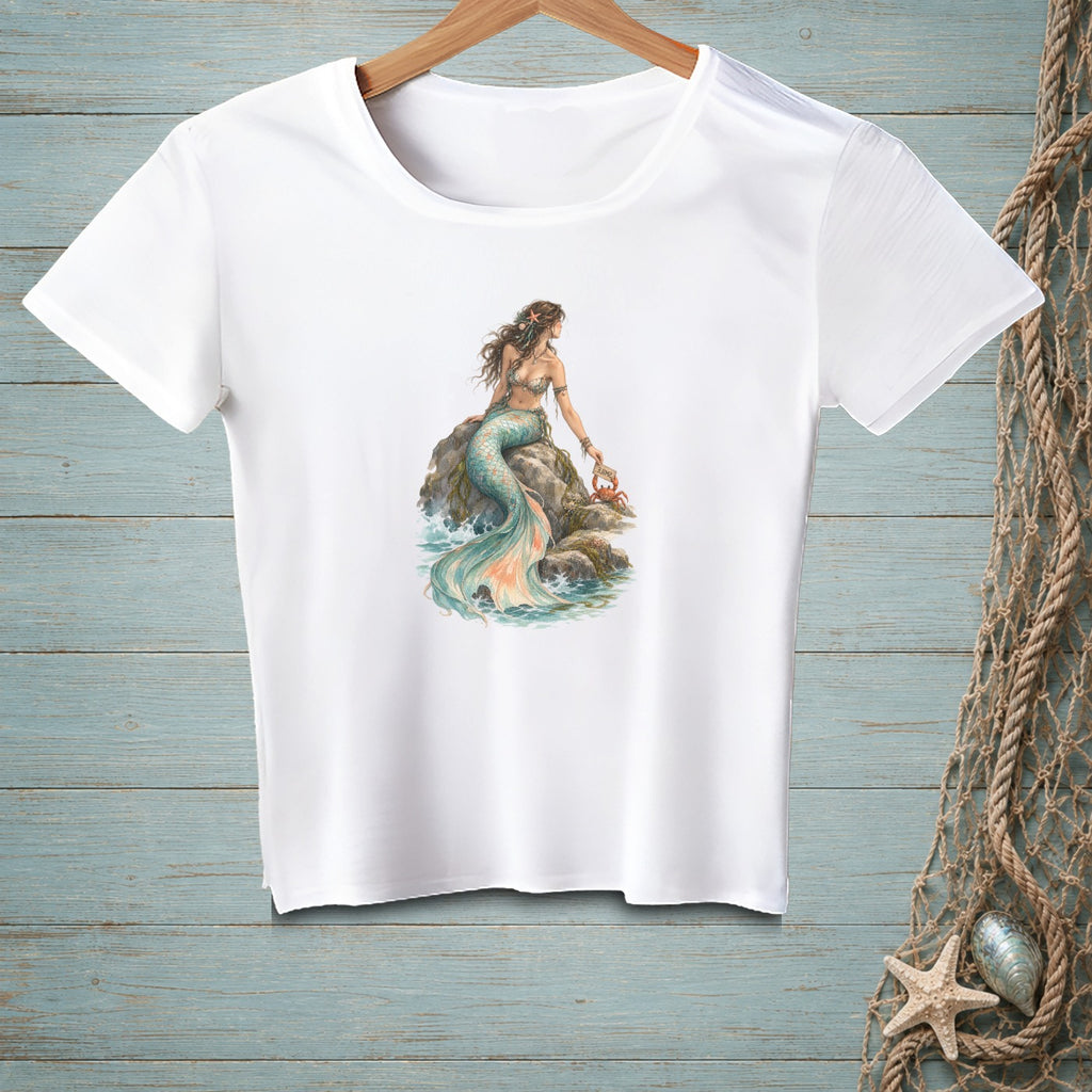 White t-shirt with a watercolor print of a mermaid and a crab on a rock.