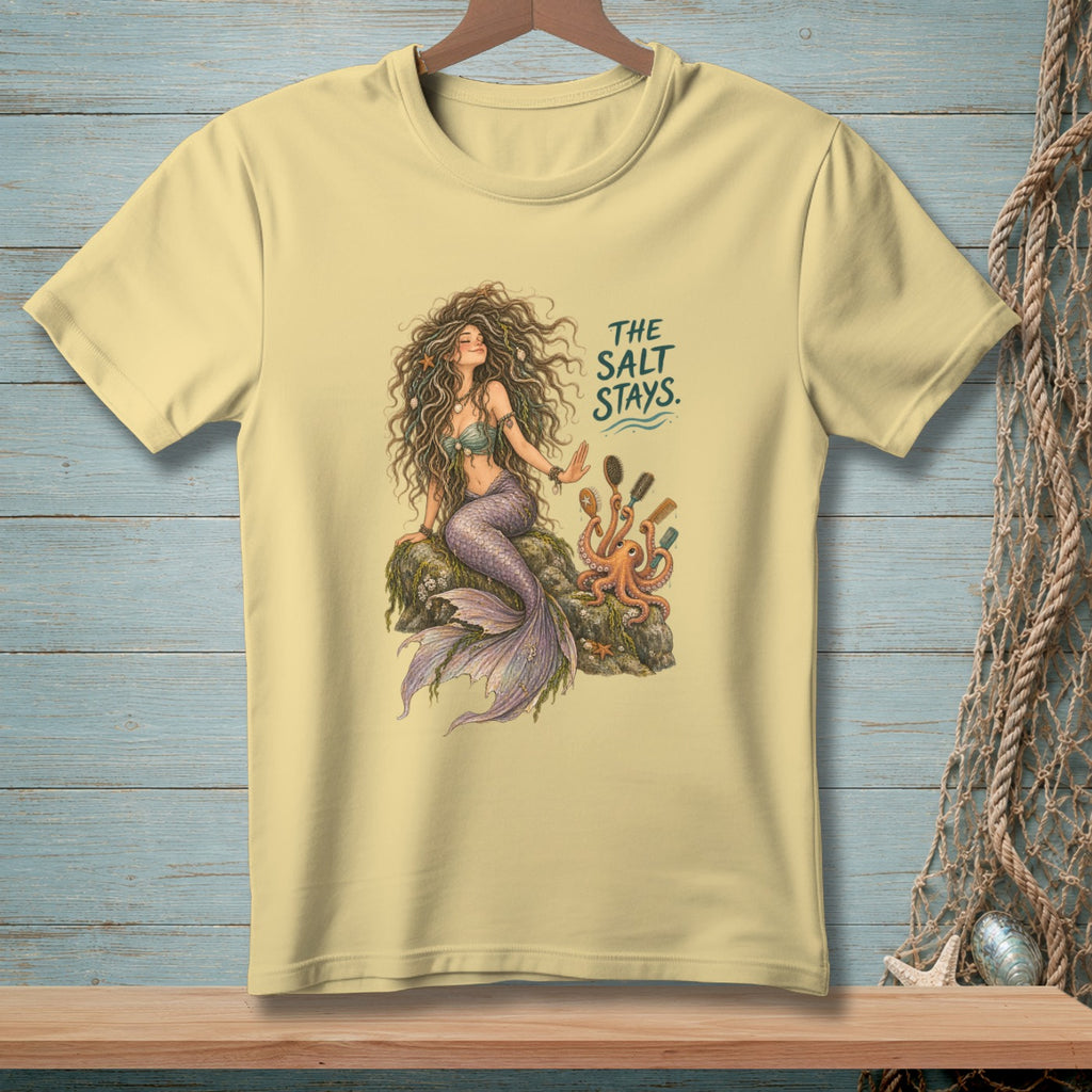 Pale yellow t-shirt with a mermaid, octopus, and the text "The Salt Stays."