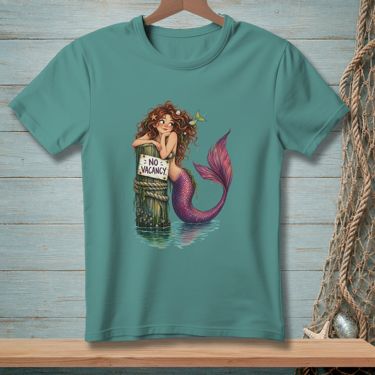 Mermaid leaning on post with "No Vacancy" sign, purple tail, on water.