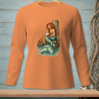 Mermaid with seashell and crab on a pier, displayed on an orange long-sleeved shirt.