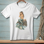 White t-shirt with a detailed illustration of a mermaid sitting on rocks.