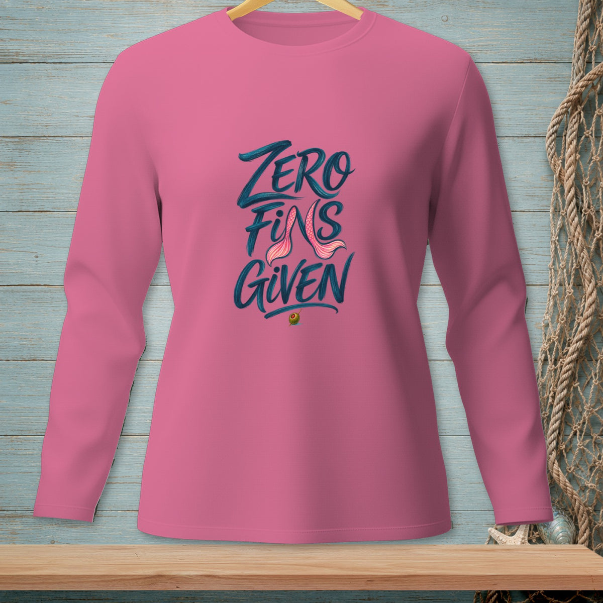 Pink long-sleeve shirt with "Zero Fins Given" text and mermaid tail graphic.