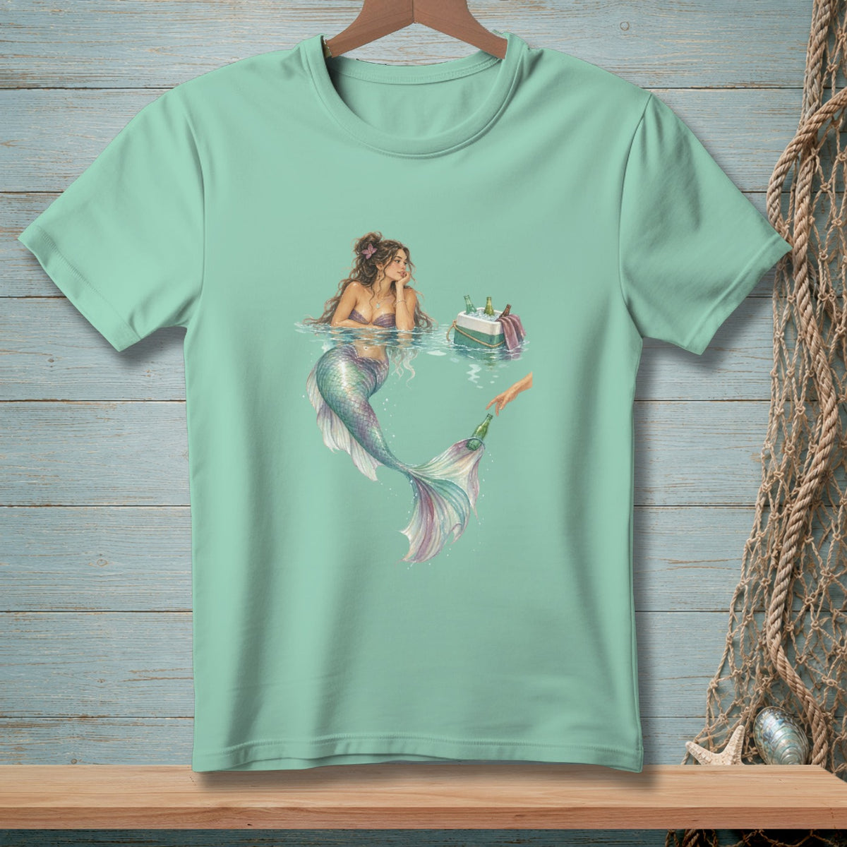 Mint t-shirt with a mermaid reaching for a drink from a cooler.