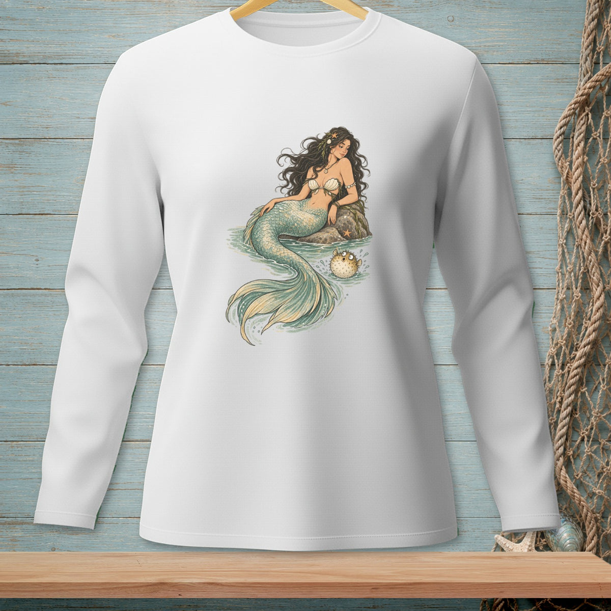 White long-sleeve shirt with a detailed illustration of a mermaid and pufferfish.