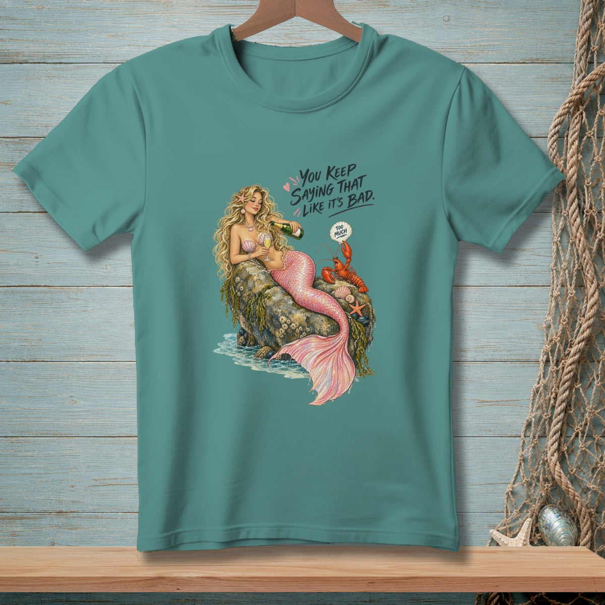 Mermaid pouring champagne on a rock with a lobster and text "You keep saying that like it's bad."