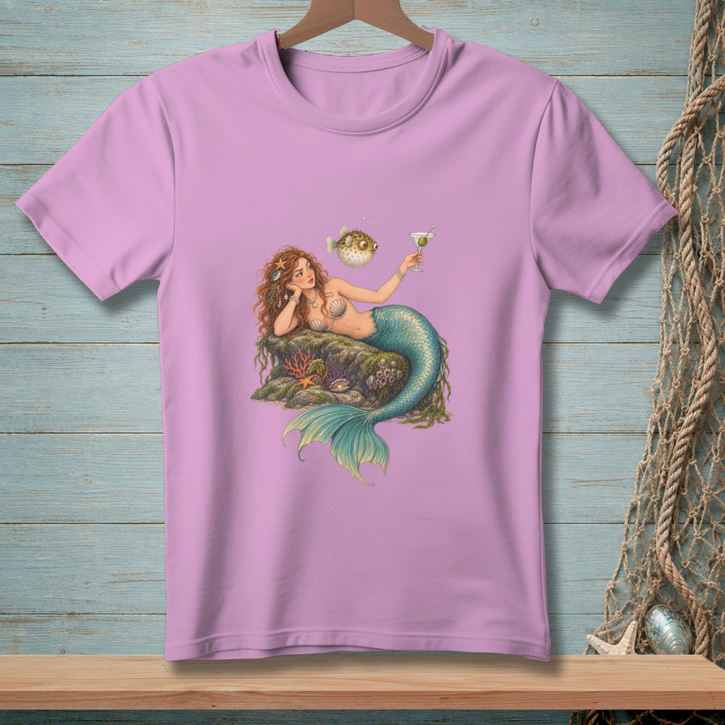 Mermaid with martini and pufferfish lounging on rocks with starfish and coral.