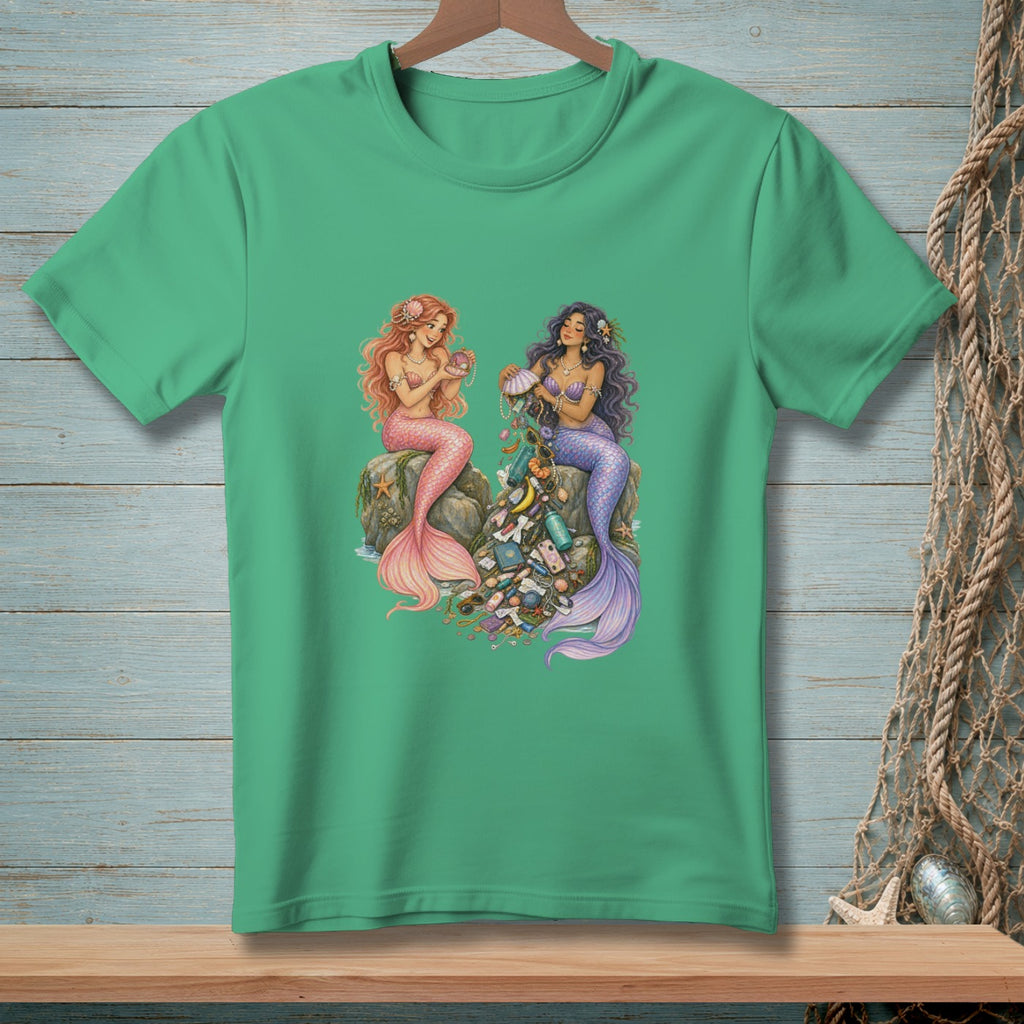 Two mermaids sit on rocks surrounded by treasures and trash.
