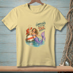 Mermaid with lobster on buoy, "Complaints Go to the Tail" text on light yellow t-shirt.