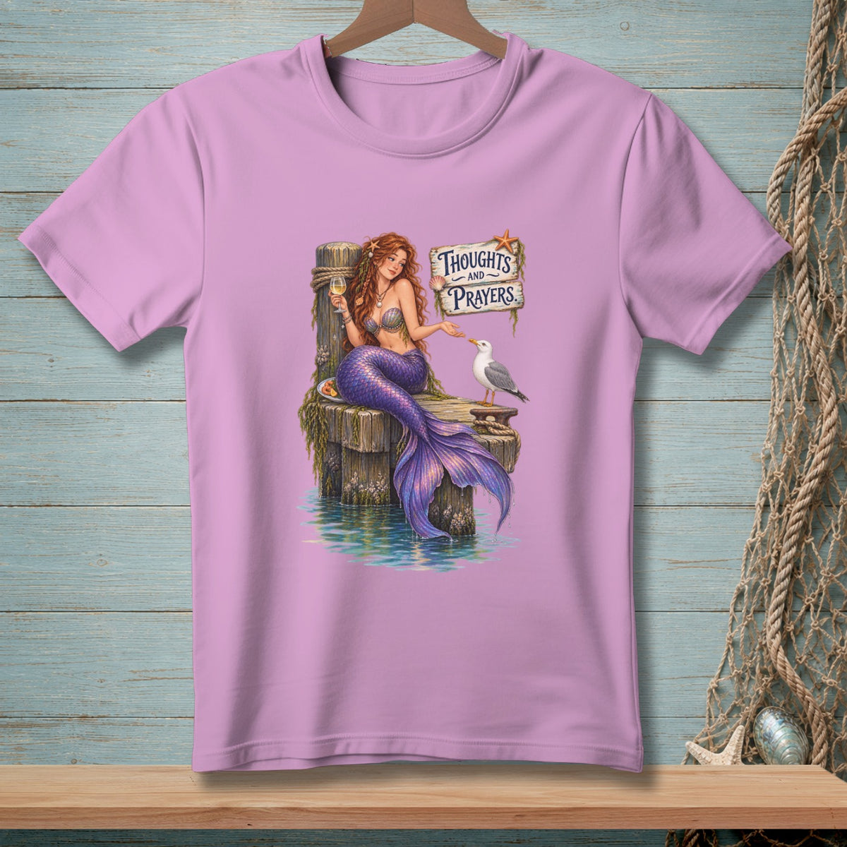 Mermaid with purple tail, holding a drink, and a seagull near "Thoughts and Prayers" sign.