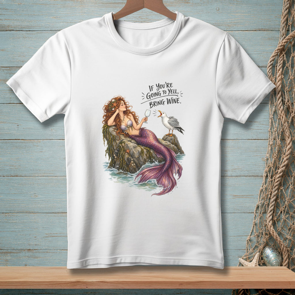 White t-shirt with illustration of a mermaid and seagull, text: "IF YOU'RE GOING TO YELL, BRING WINE."