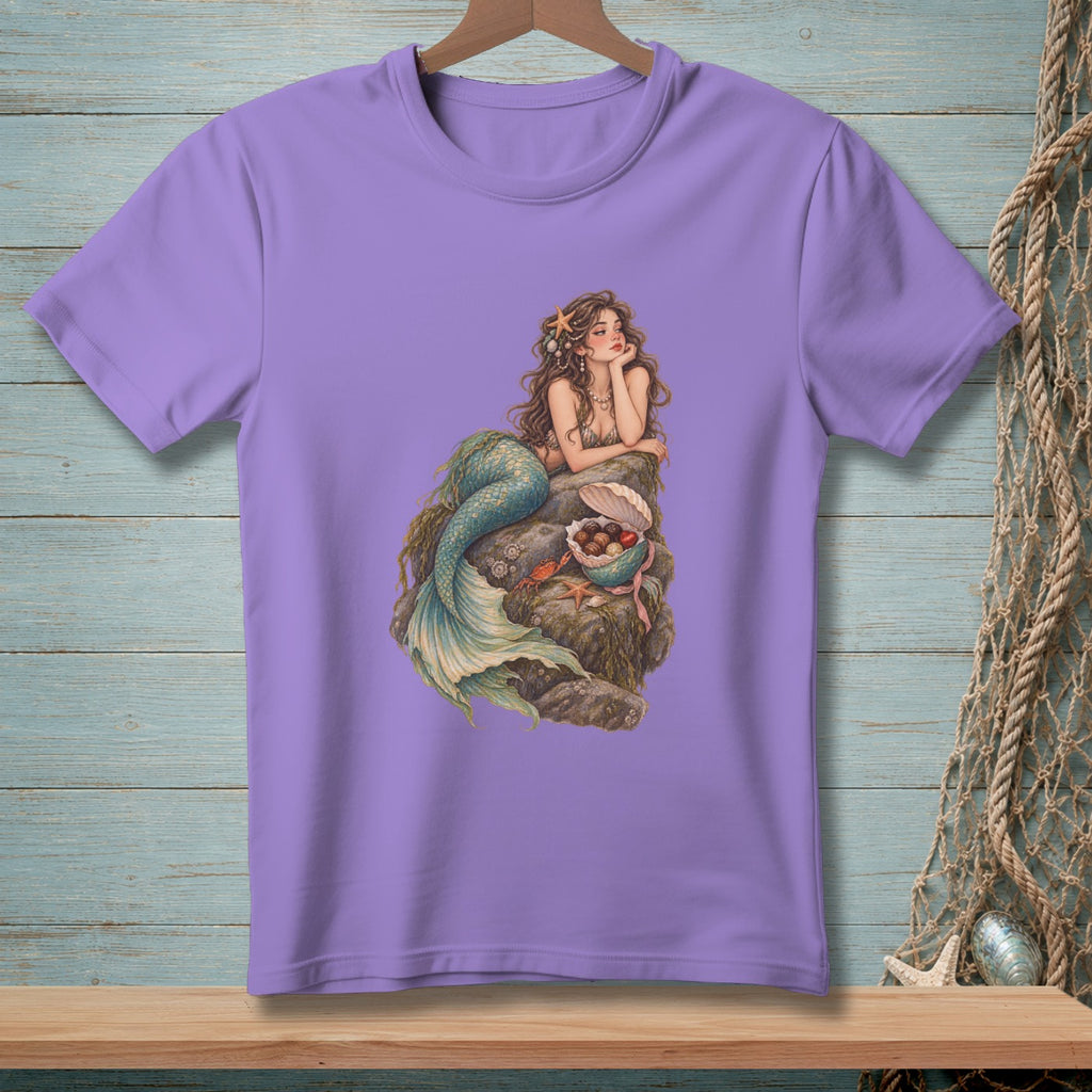Purple t-shirt with illustration of a mermaid sitting on a rock with seashells.