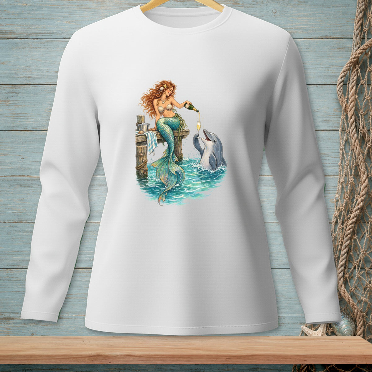 Mermaid sitting on dock pouring champagne for a dolphin in the ocean.