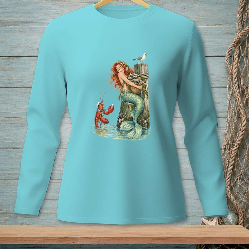 Turquoise long-sleeve shirt with mermaid, lobster, seagull, and basket of shells.