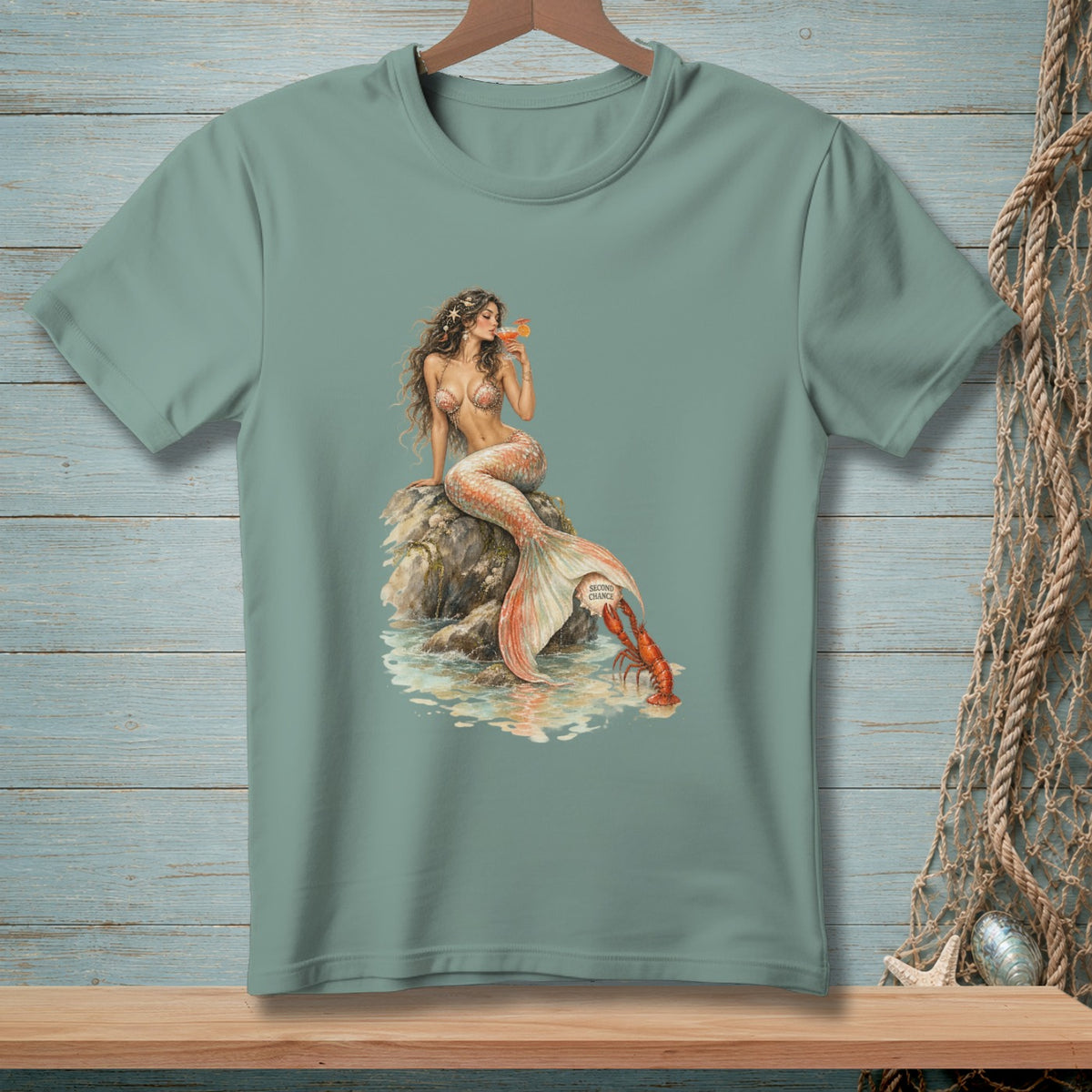 Mermaid with drink and lobster on a rock, art on t-shirt.