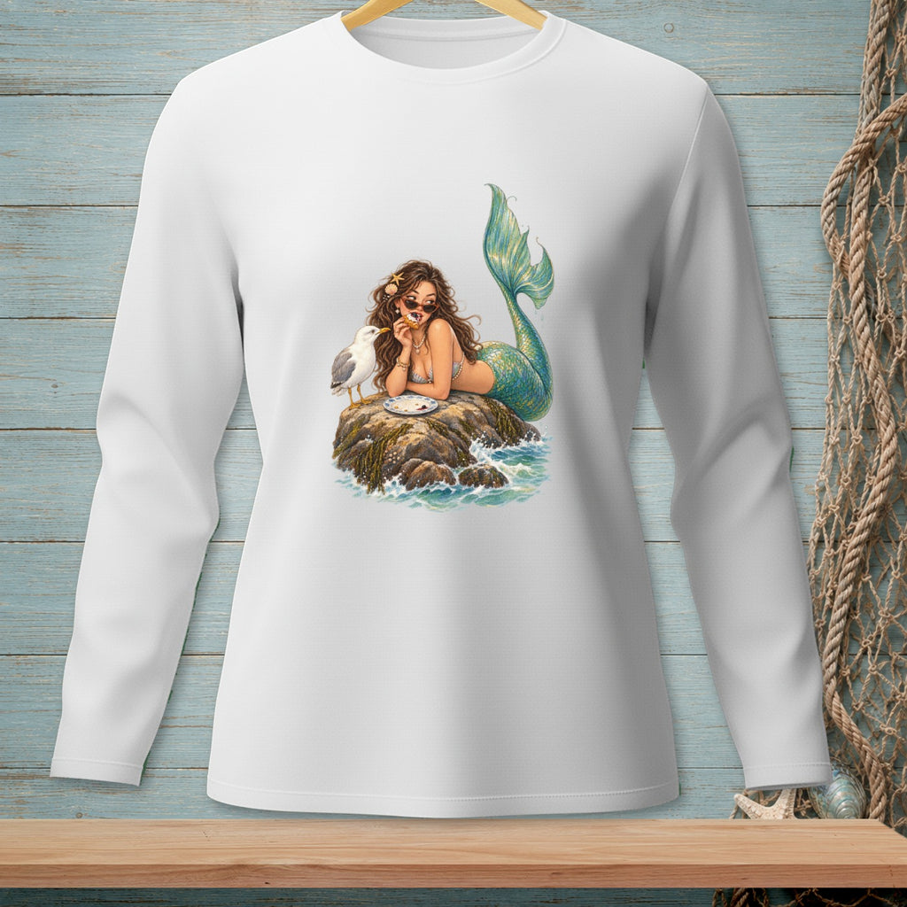 Mermaid with sunglasses rests on a rock, eating a cookie next to a seagull.