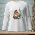 Mermaid with sunglasses rests on a rock, eating a cookie next to a seagull.