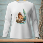 Mermaid with sunglasses rests on a rock, eating a cookie next to a seagull.