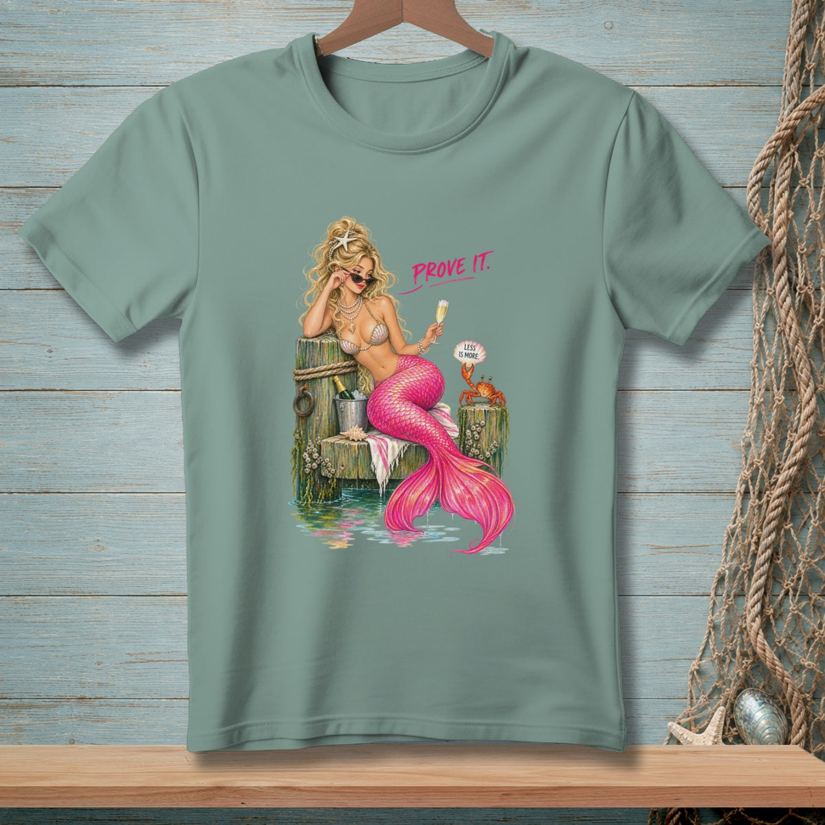 Mermaid with pink tail and sunglasses holding champagne, text "PROVE IT."