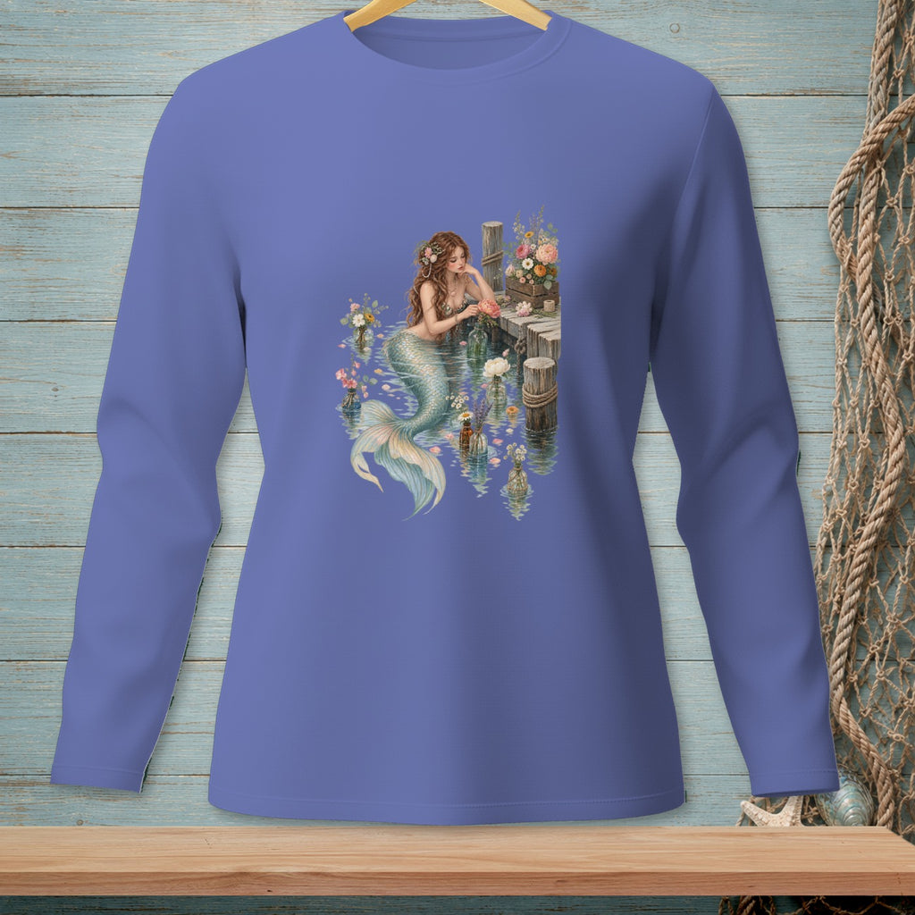 Mermaid sitting on a dock with flowers in vases.