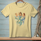 Three mermaids with champagne glasses and tails in blue and green water.