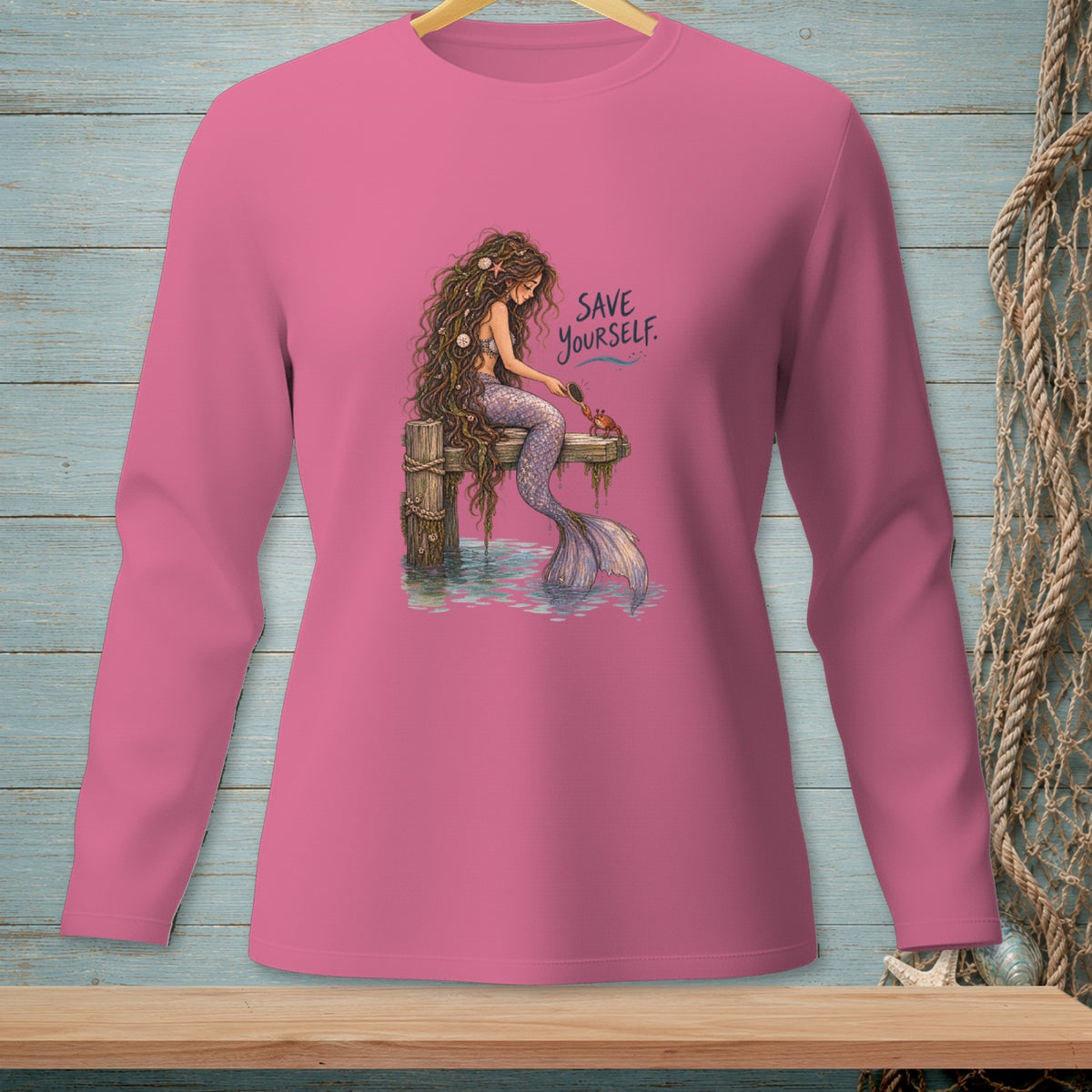 Pink long-sleeve shirt with mermaid and crab art reading "SAVE YOURSELF."