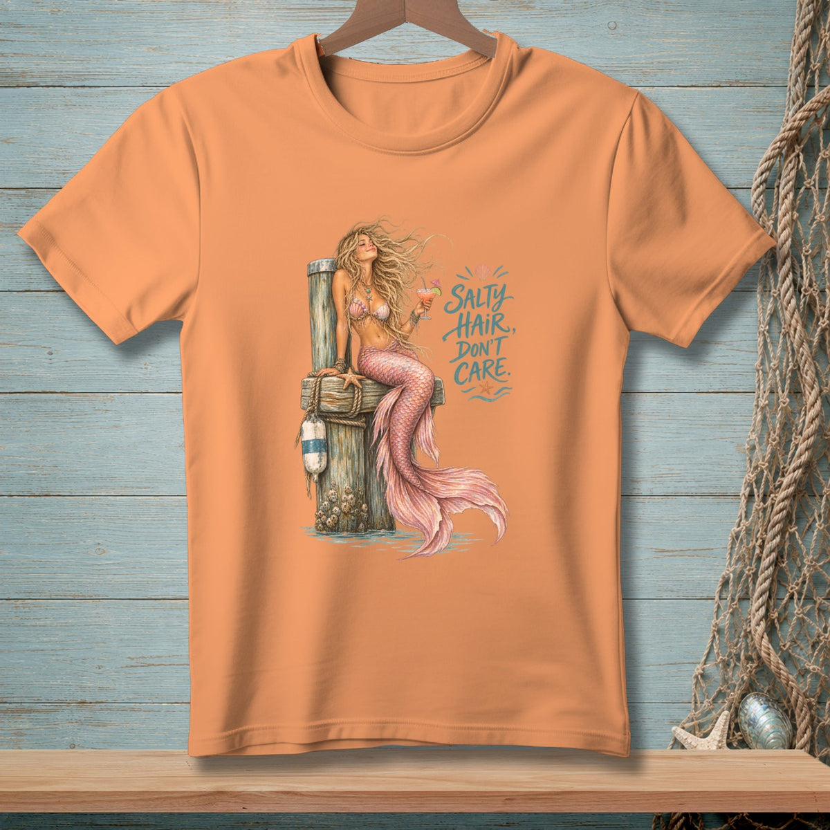 Orange t-shirt with mermaid graphic and text "Salty Hair, Don't Care".