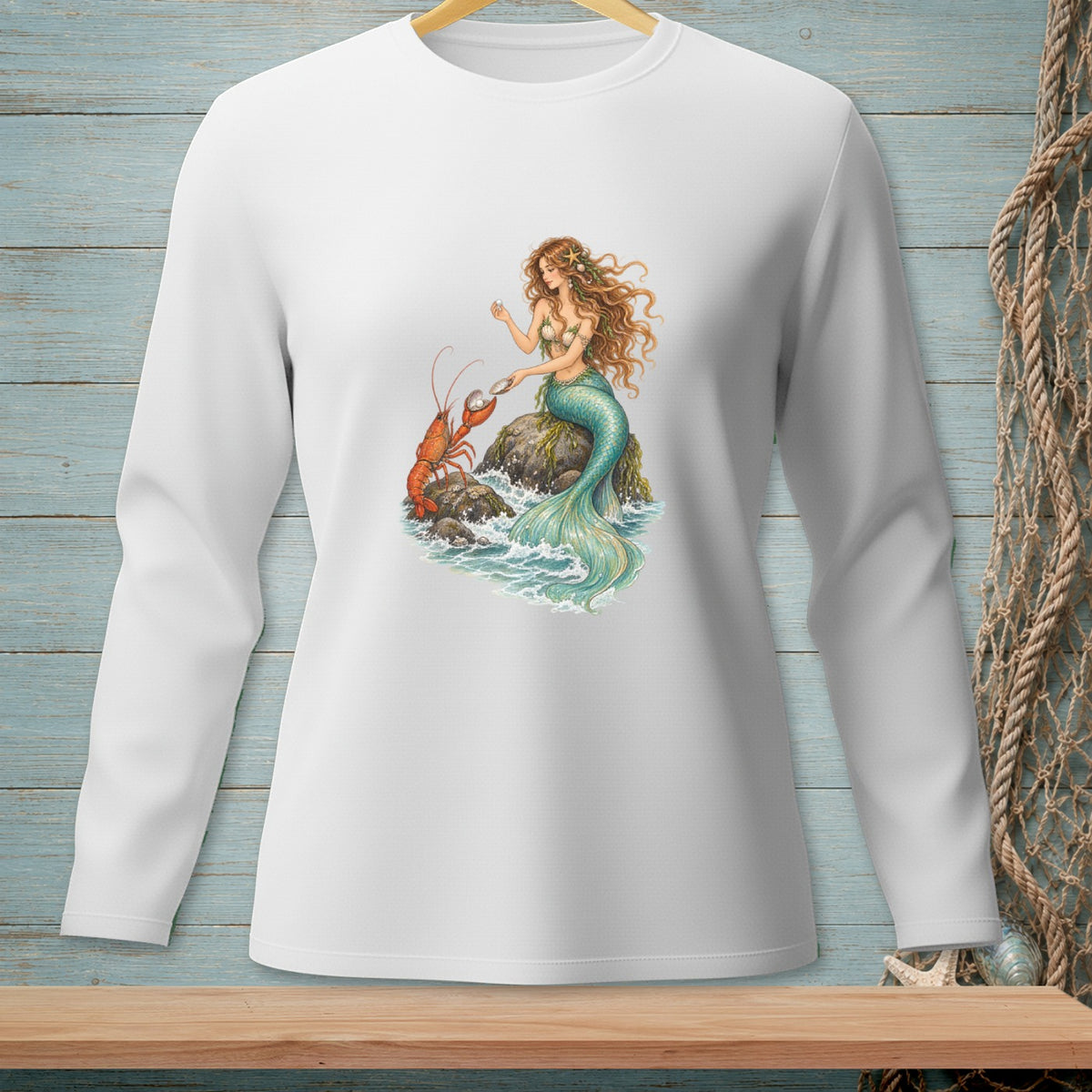 Illustration of mermaid and lobster on rocks with pearls, on a white long-sleeve shirt.
