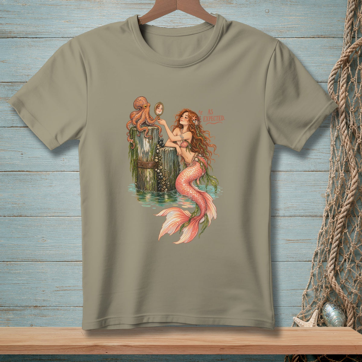 Mermaid with octopus and mirror, text "AS EXPECTED" on a tan t-shirt.