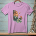 A mermaid sits by a dock holding a seashell, with a crab on a rock.