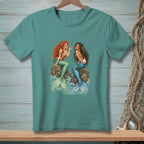 Two mermaids with colorful tails sit on rocks, one holding a pearl.
