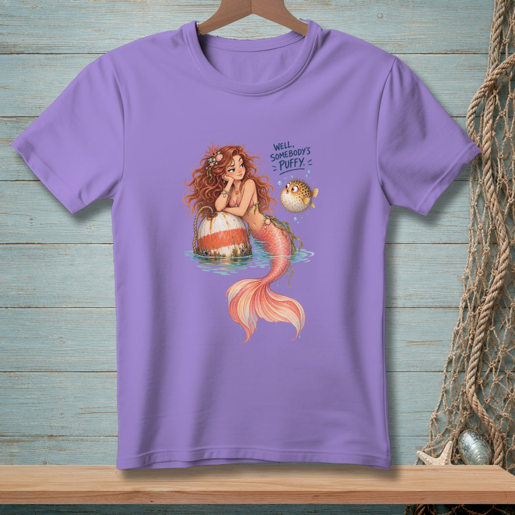 Purple t-shirt with a mermaid and pufferfish graphic that reads "Well, Somebody's Puffy!"