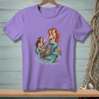 Purple t-shirt with illustration of two mermaids on a rock.