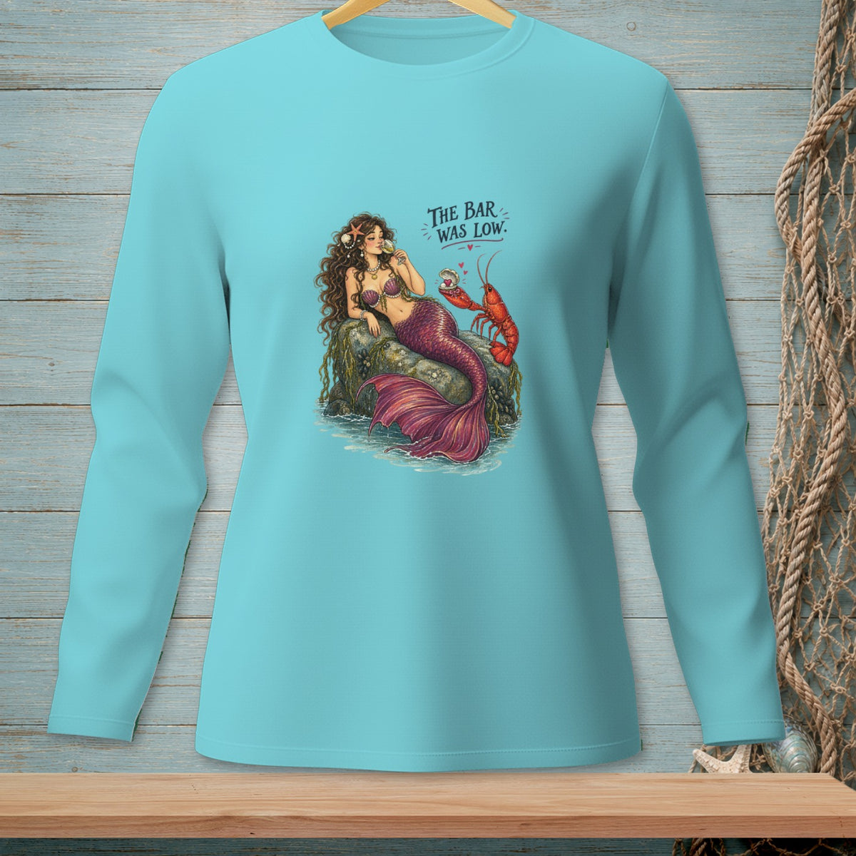 Mermaid and lobster on rocks with text "THE BAR WAS LOW."