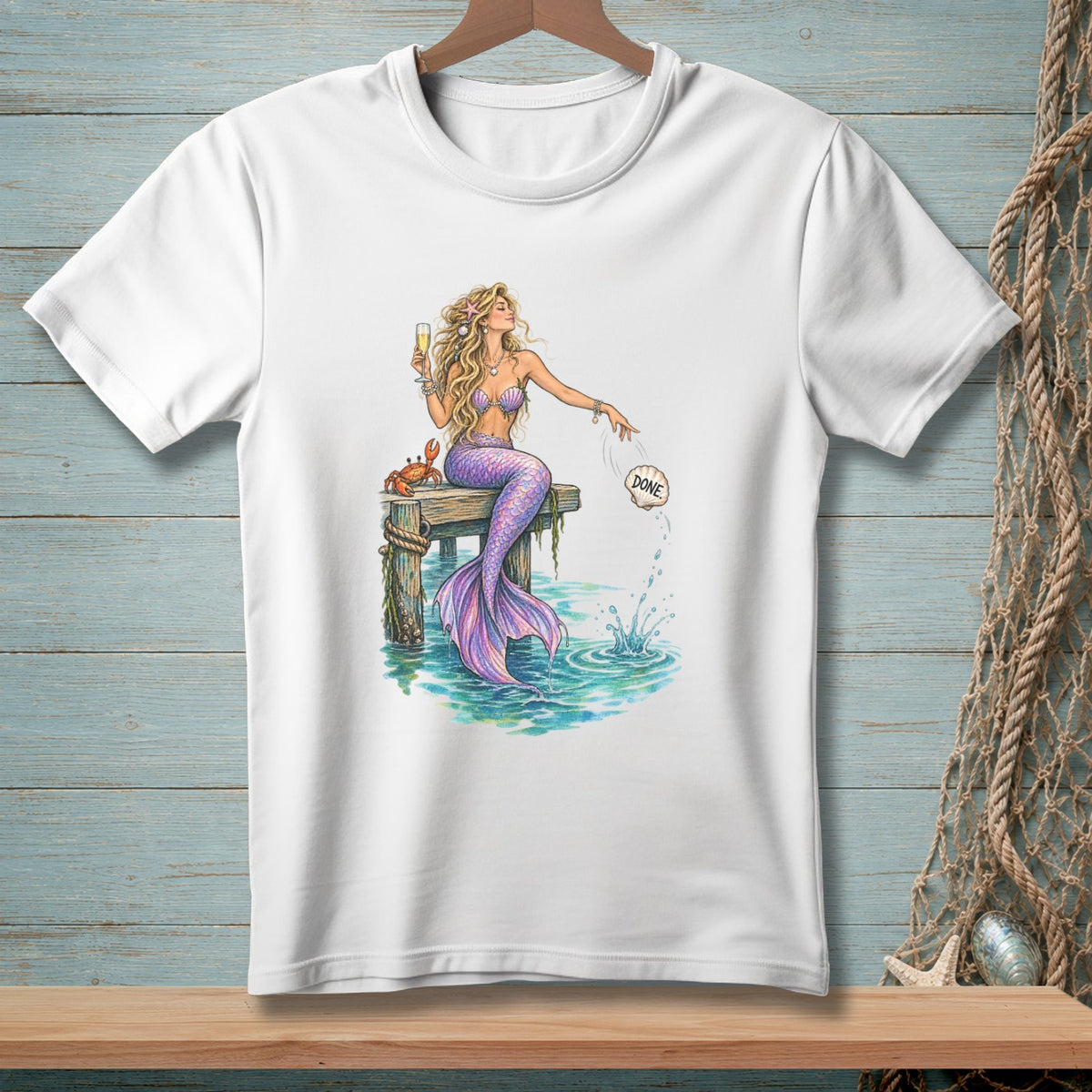 Mermaid on a dock with a crab and champagne, dropping a shell labeled "Done".